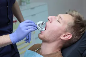 Person at the dentist office, looking at options for composite teeth bonding.