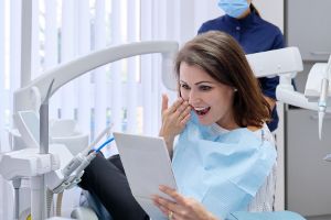 A person admiring their new dental implants in San Ramon, CA.