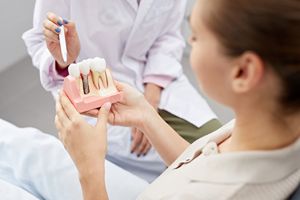 Person at the dentist's office looking at dental implants