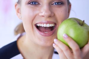 Smiling Woman About To Bite Apple