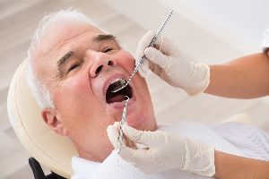 Person having teeth worked on at dentist.